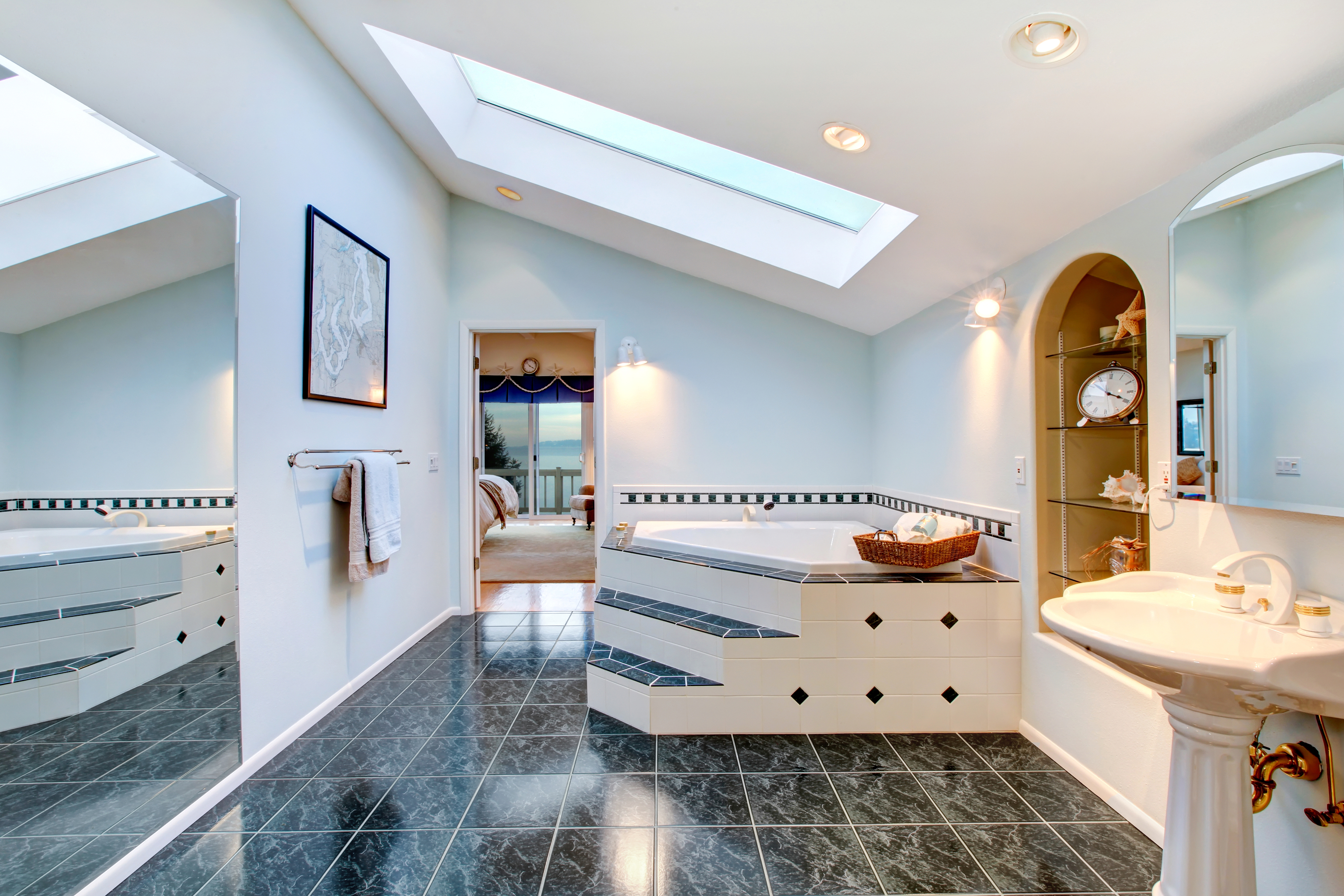 Master Bathroom With Blue Marble Tile Floor And Corner Bath Tub.